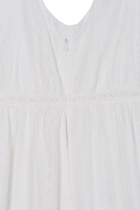 Embroidered white V neckline tiered dress